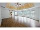 Spacious room with hardwood floors, tray ceiling and an abundance of windows overlooking the yard at 1425 Turtle Dove Ln, Lawrenceville, GA 30043