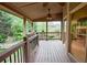 Covered porch with railing offering views of the wooded backyard at 1425 Turtle Dove Ln, Lawrenceville, GA 30043