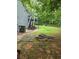 Spacious backyard featuring a fire pit, deck with stairs, and mature trees offering ample shade at 144 Boones Ridge Se Pkwy, Acworth, GA 30102