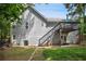 Gray two-story home with a deck, stairs, patio, and well-maintained lawn at 144 Boones Ridge Se Pkwy, Acworth, GA 30102