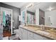 Bathroom with dual sinks, granite countertops, and walk-in shower next to a walk-in closet at 144 Boones Ridge Se Pkwy, Acworth, GA 30102