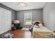 Simple bedroom with closet storage, neutral walls, laminate flooring, and natural light at 144 Boones Ridge Se Pkwy, Acworth, GA 30102