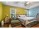 Comfortable bedroom boasts a ceiling fan, two large windows, and calming color palette at 144 Boones Ridge Se Pkwy, Acworth, GA 30102