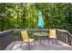 Outdoor deck with seating and umbrella, perfect for relaxing, offers a private backyard view at 144 Boones Ridge Se Pkwy, Acworth, GA 30102