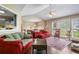 Bright living room featuring large windows, a ceiling fan, hardwood floors, and comfortable seating at 144 Boones Ridge Se Pkwy, Acworth, GA 30102