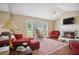 Cozy living room featuring a fireplace, ceiling fan, hardwood floors, and comfortable seating arrangements at 144 Boones Ridge Se Pkwy, Acworth, GA 30102