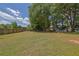Large, grassy backyard with partial fencing and shade trees at 1930 Huntcliff Dr, Lawrenceville, GA 30043