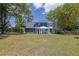 Green backyard with mature trees and outdoor seating at 1930 Huntcliff Dr, Lawrenceville, GA 30043