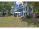 Well-manicured backyard featuring an outdoor seating area and lush green lawn at 1930 Huntcliff Dr, Lawrenceville, GA 30043