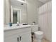 Well-lit bathroom with a white vanity, sink, and toilet at 1930 Huntcliff Dr, Lawrenceville, GA 30043