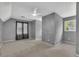 Spacious carpeted bedroom featuring a ceiling fan and natural light from the window at 1930 Huntcliff Dr, Lawrenceville, GA 30043