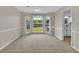 Dining room with large windows overlooking backyard and view to updated kitchen at 1930 Huntcliff Dr, Lawrenceville, GA 30043