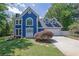 Charming blue two-story home with a well-manicured front yard and white trim at 1930 Huntcliff Dr, Lawrenceville, GA 30043