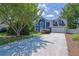 Two-story home featuring a spacious driveway and well-maintained lawn surrounded by mature trees at 1930 Huntcliff Dr, Lawrenceville, GA 30043