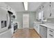 Updated kitchen with stainless steel appliances, white cabinets, and tile flooring at 1930 Huntcliff Dr, Lawrenceville, GA 30043