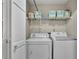 Convenient laundry room with washer, dryer, and shelving for ample storage at 1930 Huntcliff Dr, Lawrenceville, GA 30043