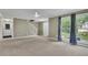 Neutral-colored living room with stairs and windows overlooking the front yard at 1930 Huntcliff Dr, Lawrenceville, GA 30043