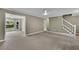 Neutral living room with stairs to second floor and view to back yard at 1930 Huntcliff Dr, Lawrenceville, GA 30043