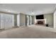 Spacious living room featuring a brick fireplace, neutral carpet, and a ceiling fan at 1930 Huntcliff Dr, Lawrenceville, GA 30043