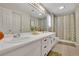 Ensuite bathroom with double vanity, large mirror, and shower with shower curtain at 1930 Huntcliff Dr, Lawrenceville, GA 30043