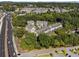 Aerial view of modern townhomes in a vibrant community, adjacent to wooded area at 2172 Peach Se Ln, Smyrna, GA 30080