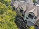 Aerial view showing the backyard and roof with greenery and neighborhood homes surrounding the property at 2172 Peach Se Ln, Smyrna, GA 30080