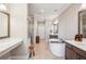 Elegant bathroom featuring dual sinks, soaking tub, and glass shower at 2172 Peach Se Ln, Smyrna, GA 30080