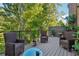 Relaxing outdoor deck with wicker seating and a view of the lush greenery at 2172 Peach Se Ln, Smyrna, GA 30080