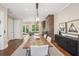 Elegant dining room with hardwood floors, stylish lighting, and a view to the backyard at 2172 Peach Se Ln, Smyrna, GA 30080