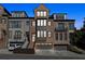 Attractive multi-story townhome with brick and gray siding, manicured landscaping, and attached garages at 2172 Peach Se Ln, Smyrna, GA 30080
