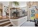 Inviting foyer with hardwood floors, elegant staircase, and a view to the bright and airy living area at 2172 Peach Se Ln, Smyrna, GA 30080
