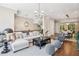 Bright, open-concept living room with hardwood floors, modern lighting, and a view to the dining area at 2172 Peach Se Ln, Smyrna, GA 30080