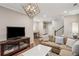 Open-concept living room with modern lighting, hardwood floors, and comfortable seating near desk and staircase at 2172 Peach Se Ln, Smyrna, GA 30080