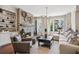 Comfortable living room with stone fireplace, built-in shelves, and large windows at 2172 Peach Se Ln, Smyrna, GA 30080