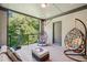 Comfortable patio featuring hanging swing chairs and seating with natural light and view of lush greenery at 2172 Peach Se Ln, Smyrna, GA 30080