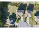Bird's eye view shows multiple residences with well-manicured lawns in a serene, suburban setting at 3204 Ivy Farm Path, Buford, GA 30519