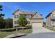 Two-story brick home with a well-manicured lawn, mature trees, and attached two-car garage at 3204 Ivy Farm Path, Buford, GA 30519