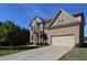 Charming two-story brick home with manicured lawn, a two-car garage and inviting curb appeal at 3204 Ivy Farm Path, Buford, GA 30519