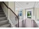 Foyer with hardwood floors, a staircase, and white trim showcases the open transition between rooms at 3204 Ivy Farm Path, Buford, GA 30519