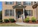 Inviting front porch with brick steps, decorative columns, and meticulously maintained landscaping at 3204 Ivy Farm Path, Buford, GA 30519