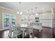 Bright kitchen features white cabinets, an island, stainless appliances, and access to the deck at 3204 Ivy Farm Path, Buford, GA 30519