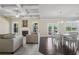 Open-concept living space with hardwood floors, fireplace, and access to an outdoor patio at 3204 Ivy Farm Path, Buford, GA 30519
