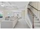 Open-concept living room with tray ceiling, recessed lighting, and stairs to the upper level at 3204 Ivy Farm Path, Buford, GA 30519