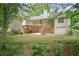 Back of home featuring a deck, backyard, and a two-car garage at 418 Whisper Wood Way, Locust Grove, GA 30248
