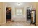 Bright bathroom with a central soaking tub, flanked by walk-in closets, offering ample space and storage at 418 Whisper Wood Way, Locust Grove, GA 30248