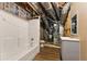 Unfinished bathroom with exposed pipes, a new shower-tub combo, vanity and toilet at 418 Whisper Wood Way, Locust Grove, GA 30248