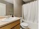Neutral bathroom featuring a single sink vanity, toilet, and shower-tub combo with a white shower curtain at 418 Whisper Wood Way, Locust Grove, GA 30248