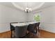 Bright dining room featuring modern chandelier, stylish chairs and a large window that offers plenty of natural light at 418 Whisper Wood Way, Locust Grove, GA 30248
