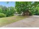 Charming traditional home with a porch and well-manicured front lawn at 418 Whisper Wood Way, Locust Grove, GA 30248