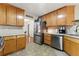 Spacious kitchen featuring stainless steel appliances and ample cabinet space at 418 Whisper Wood Way, Locust Grove, GA 30248